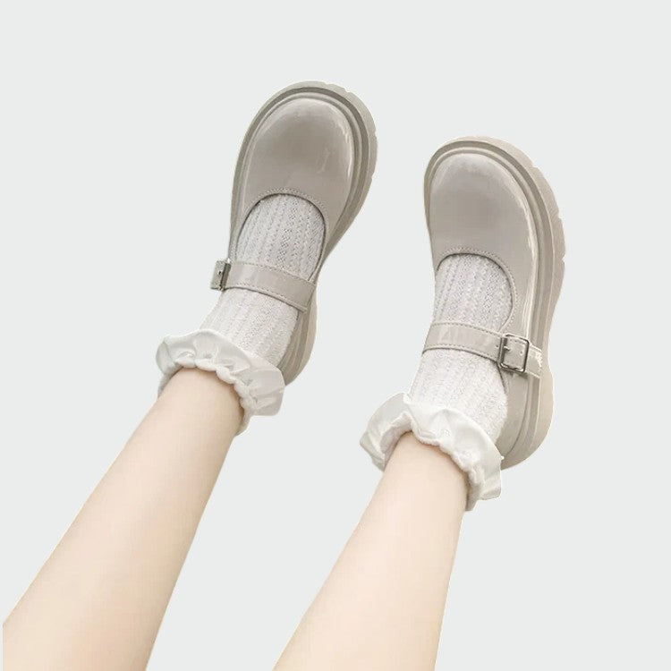 Glossy black Mary Jane shoes for women with an adjustable strap, a timeless and versatile footwear choice