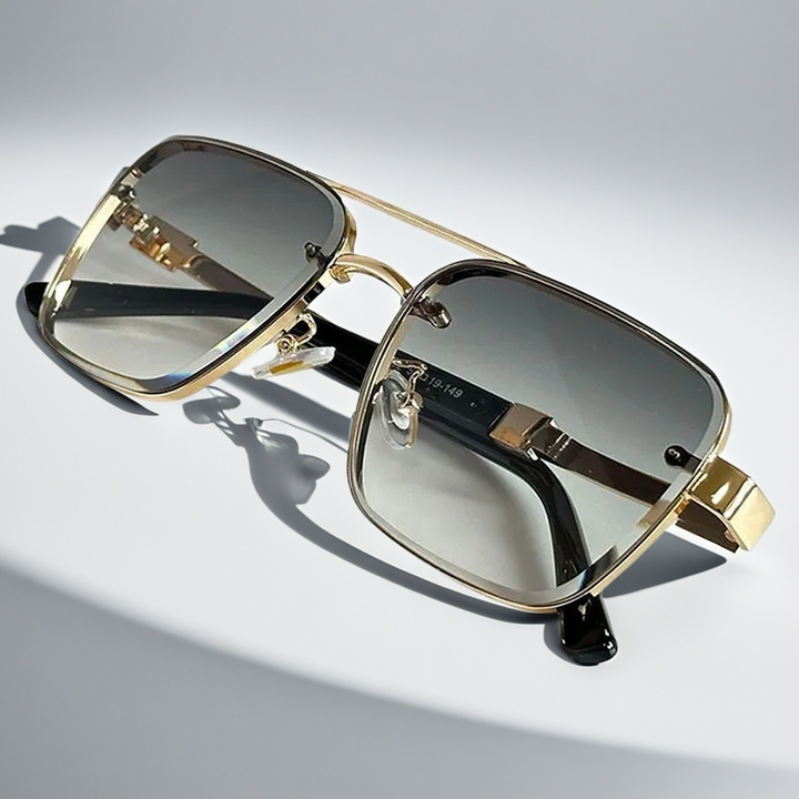Chic unisex squared sunglasses with a sleek gold frame. Gradient lenses offer UV protection for a modern look.