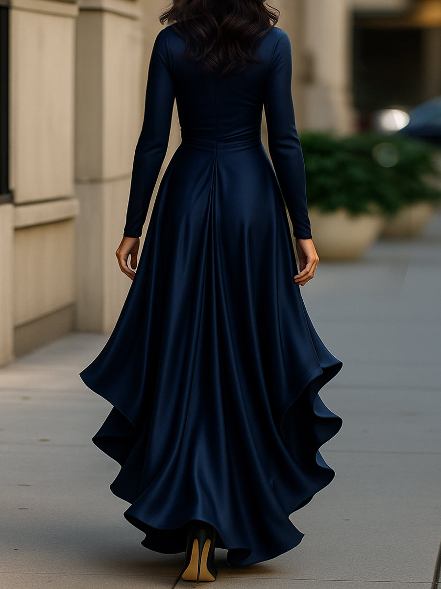 Close-up: Elegant pleated fabric & delicate ruffle hem on women's long sleeve V-neck maxi dress.