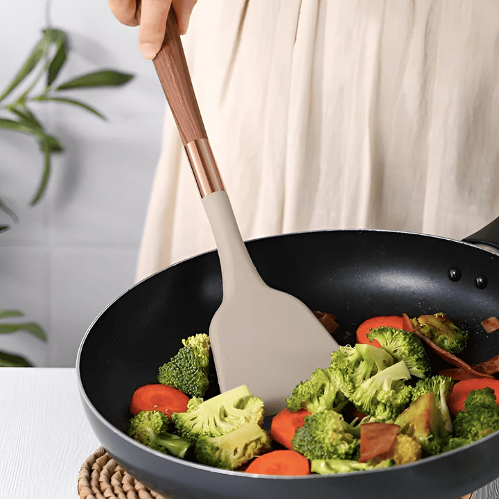 Versatile 10-piece cooking tool set: silicone spatulas, whisks, & serving spoons with ergonomic wood handles.