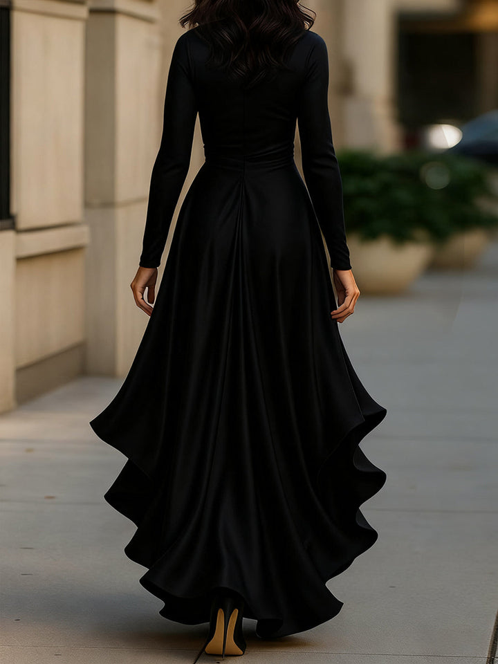 Woman in flowing pleated ruffle maxi dress, long sleeve V-neck, walking gracefully for an elegant event.