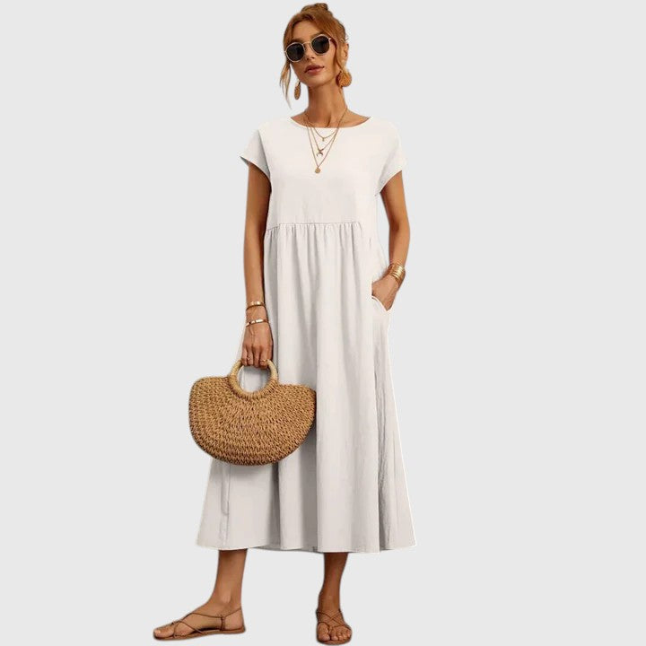 Versatile women's midi dress, short sleeve with pockets & round neck, offering effortless chic & comfort.