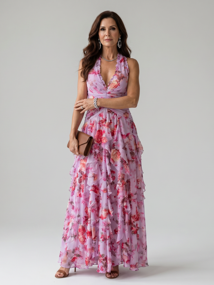 Women's halter neck floral maxi dress with ruched bodice & ruffle skirt, perfect for elegant summer parties. [[lstfy-media:1]]