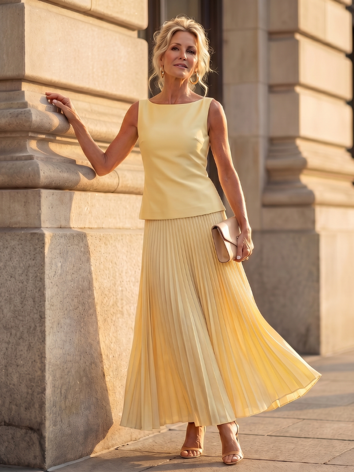 Women's elegant structured bodice & pleated skirt set. Chic sleeveless two-piece outfit.