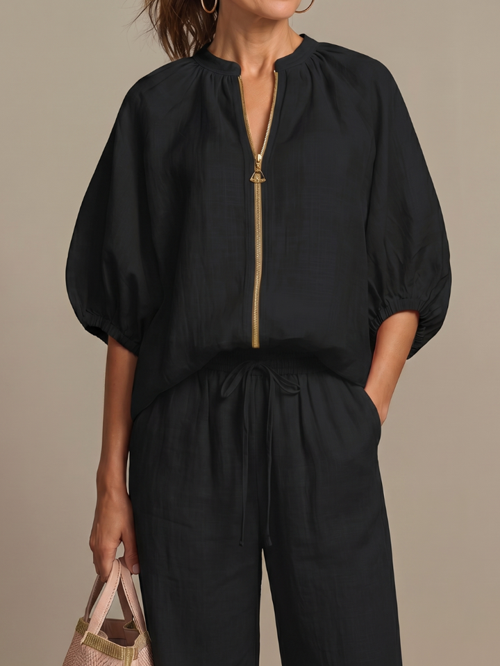 Relaxed fit women's two-piece set: zip front blouse & wide leg pants. Ideal for comfortable summer style.