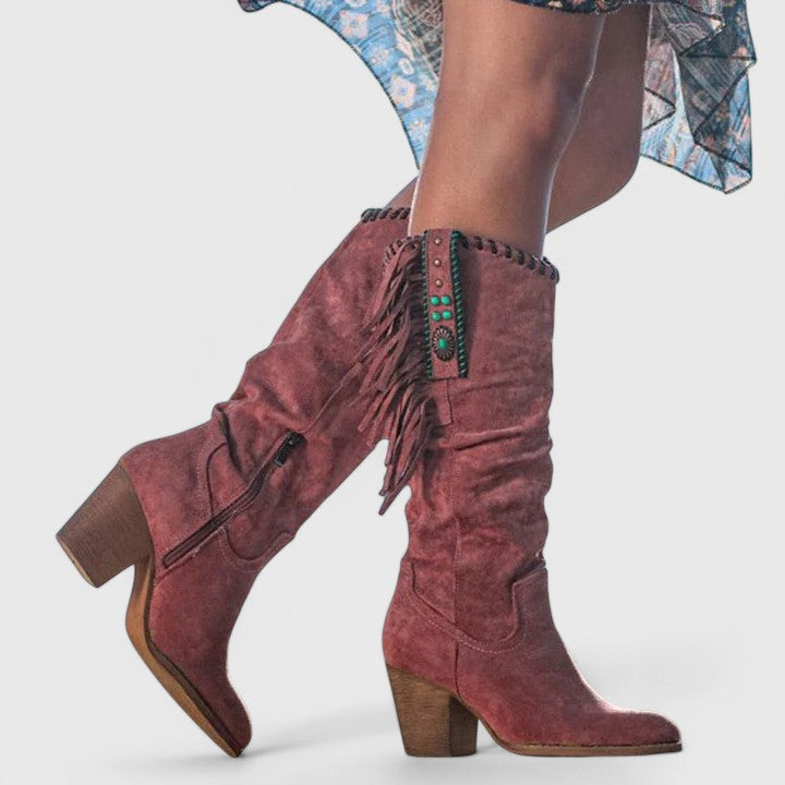 Fashionable women's mid-calf boots with eye-catching fringe and a stable block heel, enhancing your winter style.