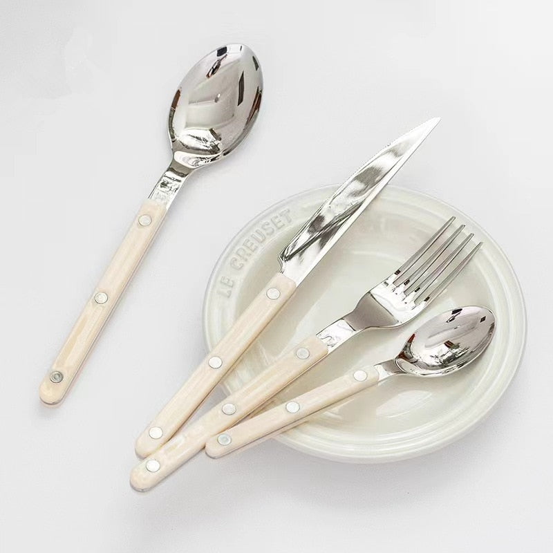 Complete 24-piece stainless steel dining set with polished modern flatware and elegant cutlery.