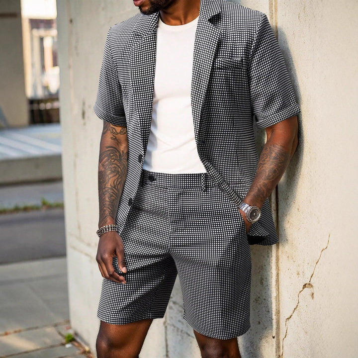 Men's modern black check print blazer and coordinating shorts, a fashionable two-piece summer outfit.