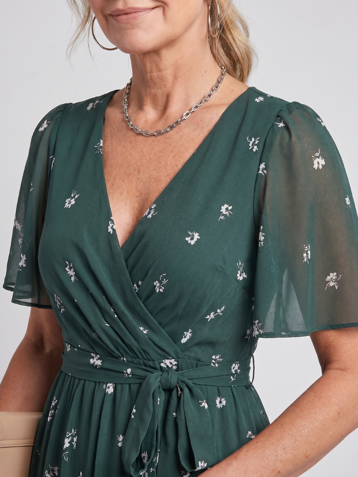 Stylish women's summer midi dress, vibrant floral print, v-neck, and delicate flutter sleeves.