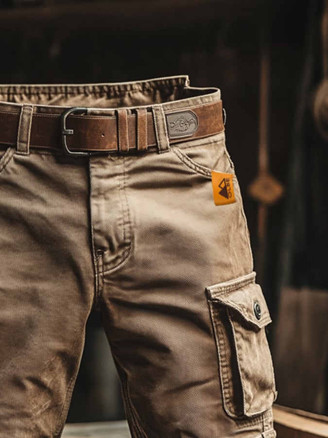 Black men's adventure cargo pants with multiple pockets, offering rugged style & versatility.