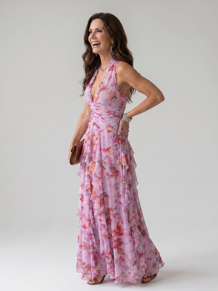 Elegant women's halter neck maxi dress with vibrant floral print, ruched bodice, and flowing ruffle skirt design. [[lstfy-media:2]]