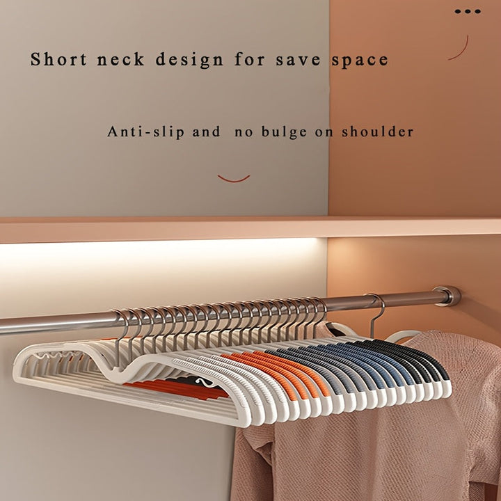 Set of 40 space-saving plastic clothes hangers with non-slip grip and rotating hook for neat wardrobe storage.