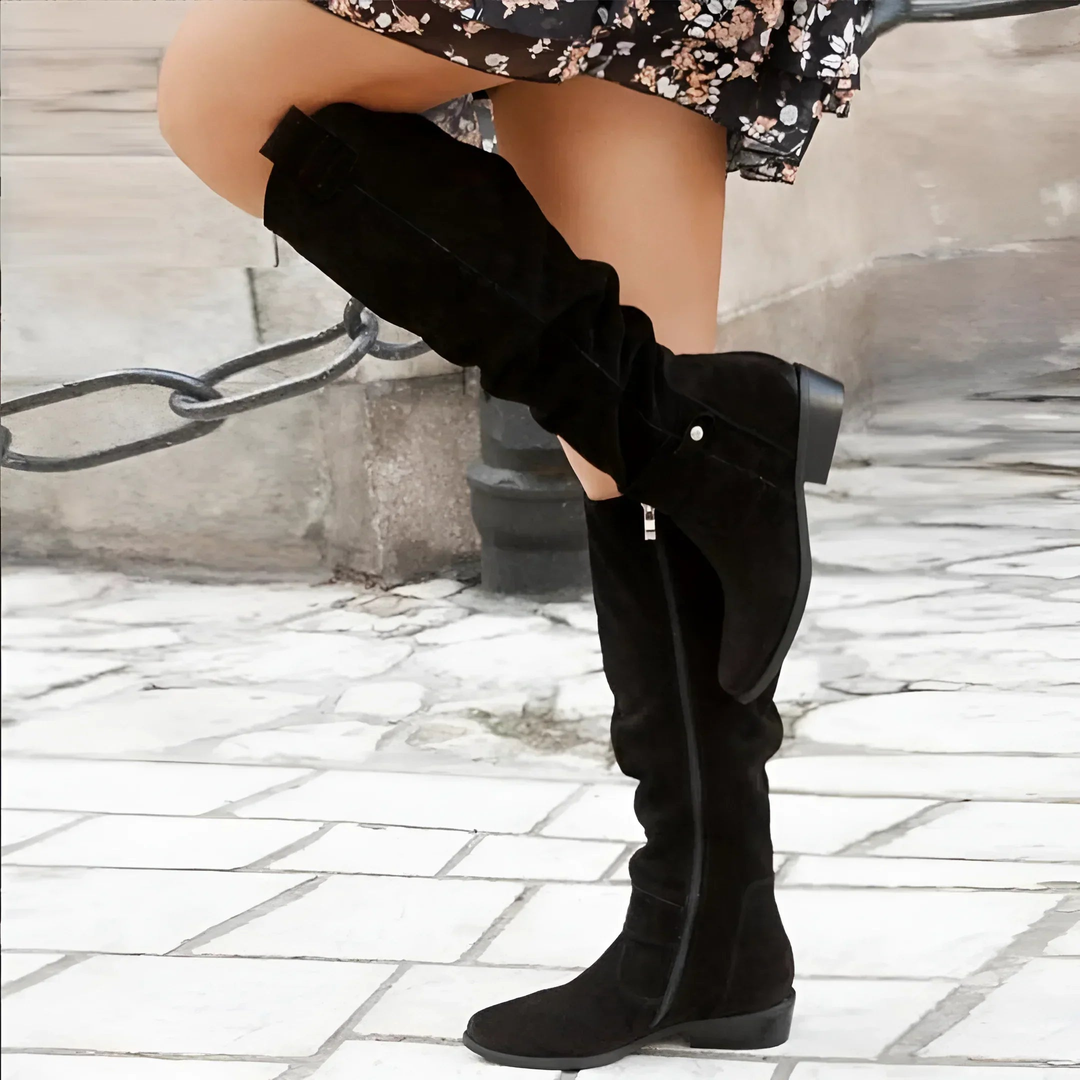 Rich brown women's tall boots, designed with a stable block heel & sophisticated strap embellishments.