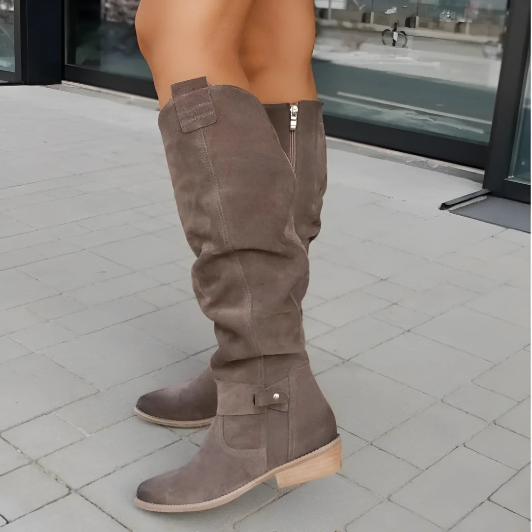 Versatile fall/winter women's knee-high boots with a chic block heel & tasteful strap design.