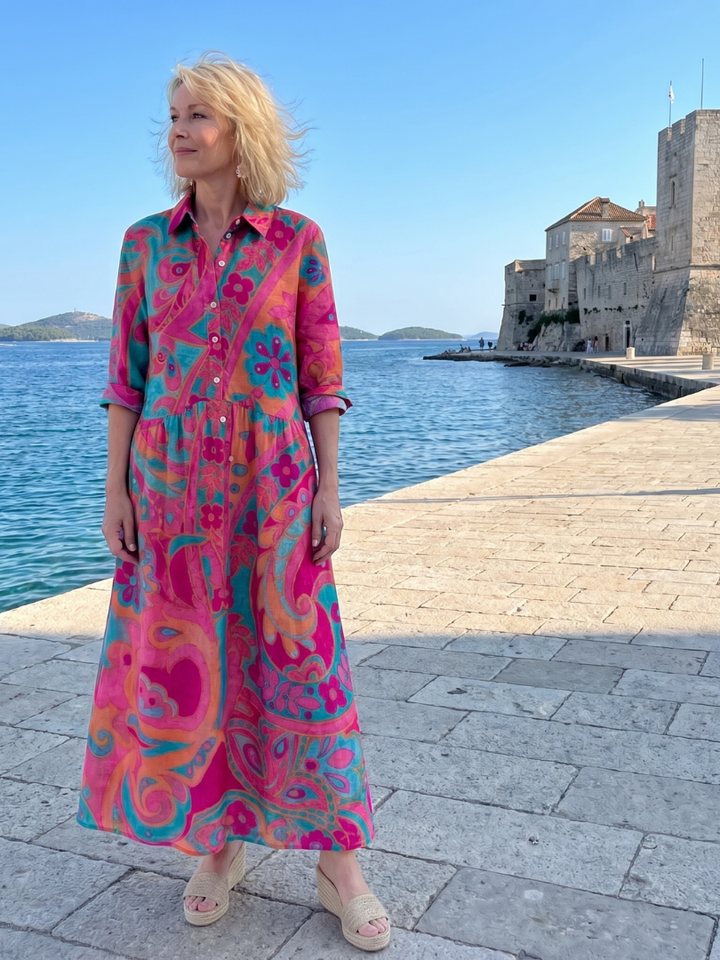 Close-up of a women's printed collared midi dress with button front details. Relaxed fit, great for travel.