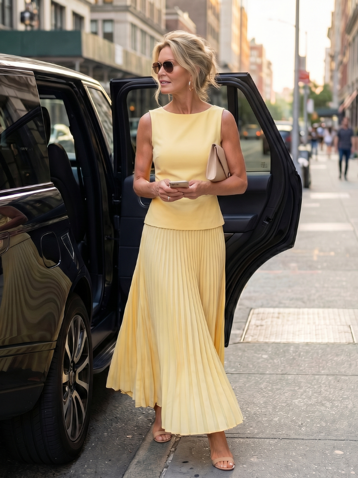 Casual women's elegant two-piece set featuring a structured bodice and a stylish pleated skirt.