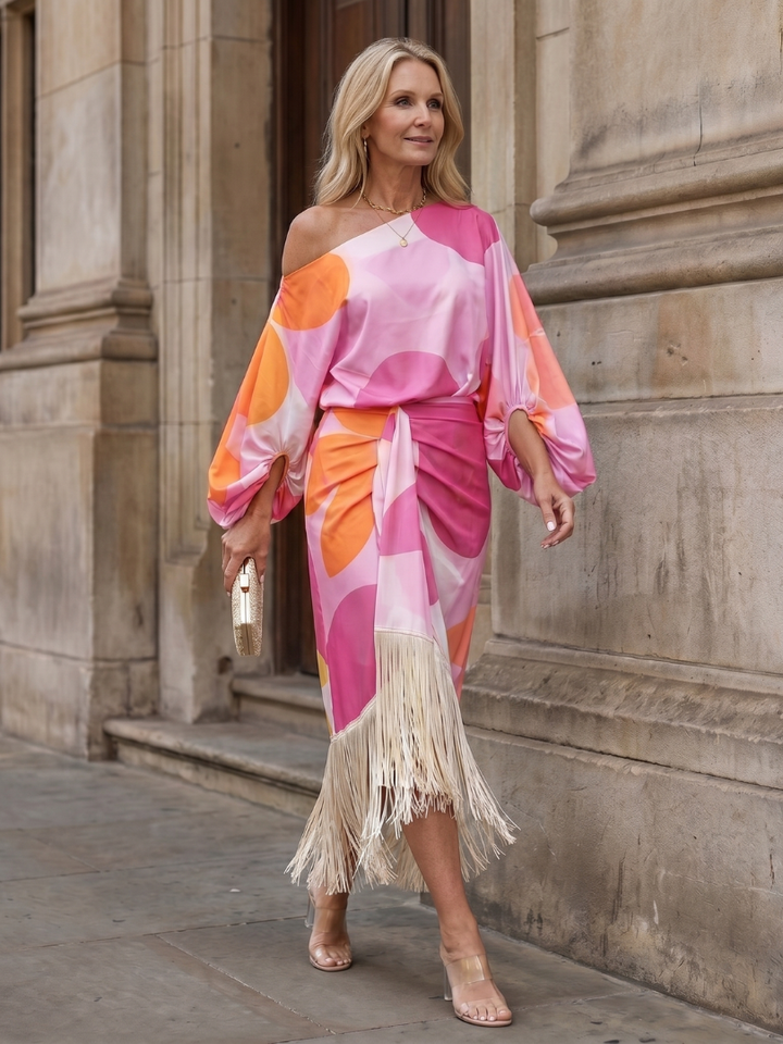 Unique and elegant women's midi dress with abstract print, off-shoulder, long sleeves, and chic fringe detailing.