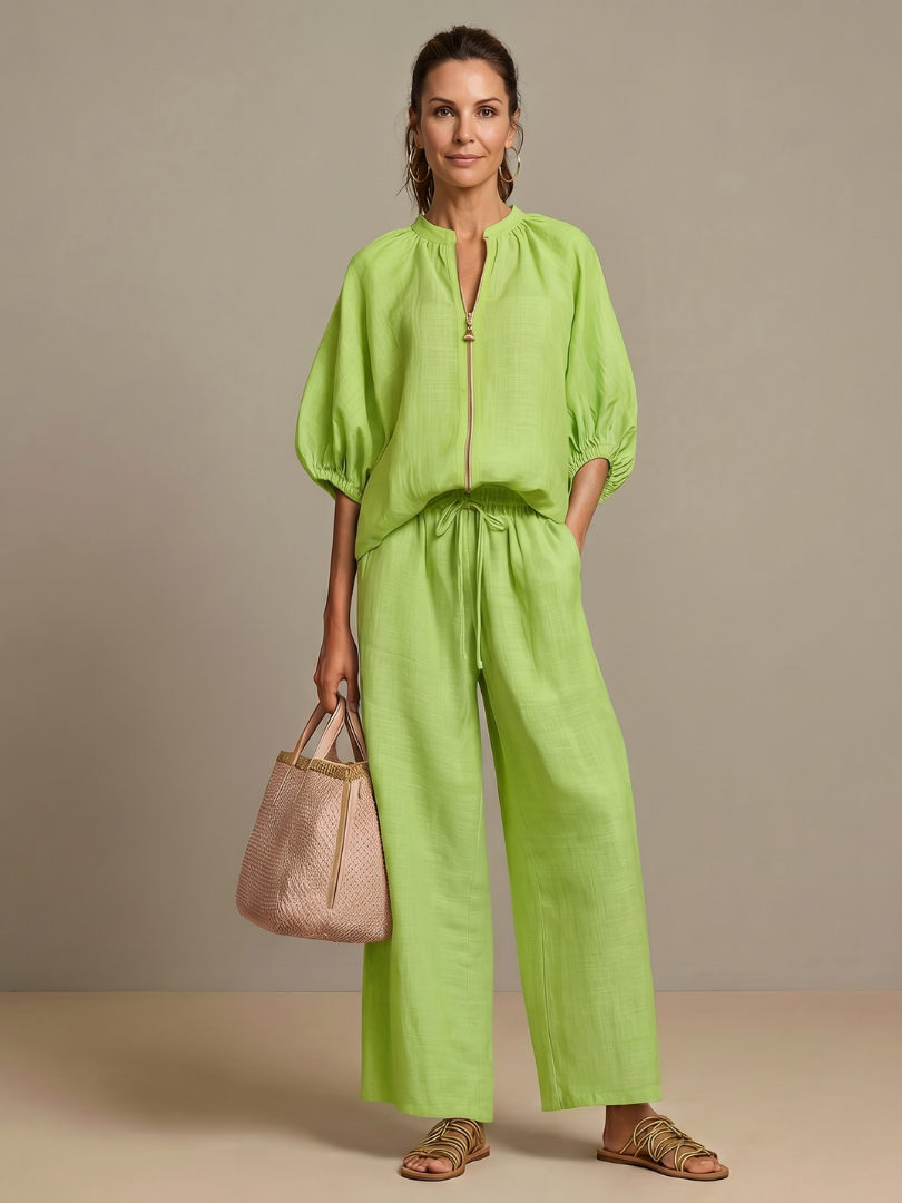 Relaxed fit women's two-piece outfit with a stylish zip front blouse & flowy wide-leg pants. Summer ready.