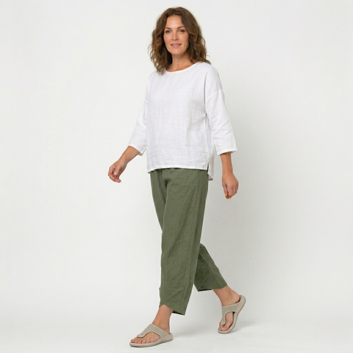 Women's relaxed fit high-waisted trousers, featuring a unique tulip hem. Chic and comfortable casual pants.