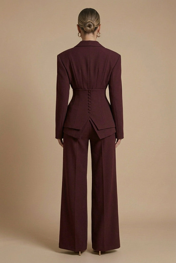 Chic women's tailored suit with a sharp peaked lapel blazer and flowing wide-leg trousers. Perfect for power dressing.