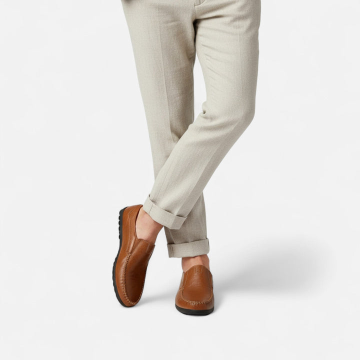Stylish men's leather loafers with intricate stitching, offering versatile comfort for everyday or dress.