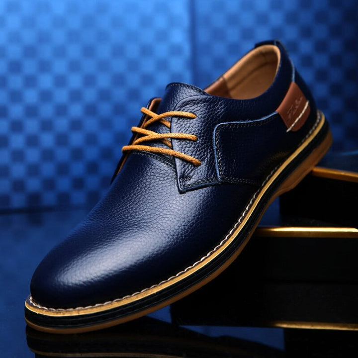 Elegant men's brown leather Oxford dress shoes, perfect for formal occasions, business, or office wear. Classic lace-up style.