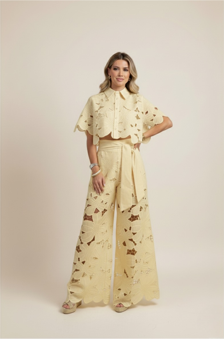 Casual chic women's outfit: floral embroidered top paired with wide-leg summer pants.