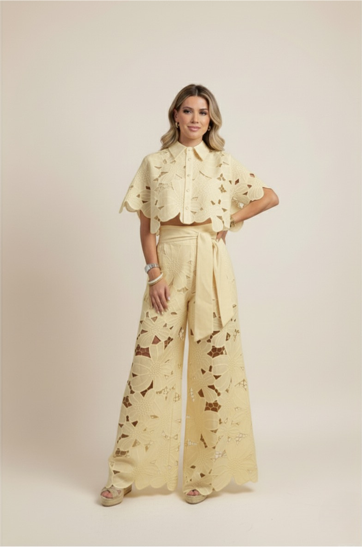Casual chic women's outfit: floral embroidered top paired with wide-leg summer pants.
