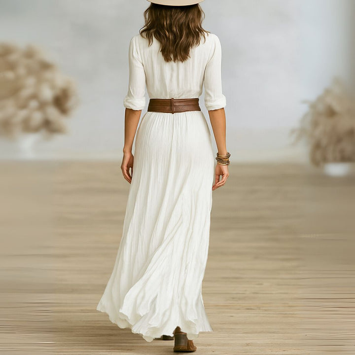 Fashionable women's long belted shirt dress. Elegant maxi style with a shawl collar for a refined, modern look.