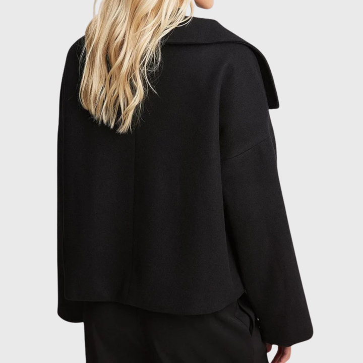 Stylish women's cropped double-breasted coat, wide lapel. Modern outerwear for a sleek look.