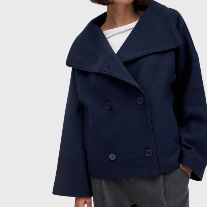 Fashionable women's cropped double-breasted jacket featuring wide lapels. Elegant chic outerwear.