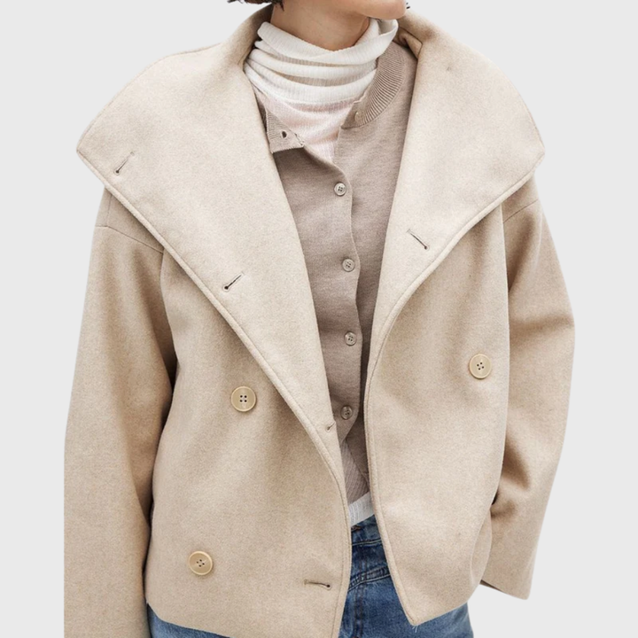 Chic women's cropped coat, double-breasted design & wide lapel detail. Modern women's apparel.