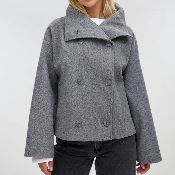 Elegant women's cropped double-breasted jacket, wide lapel detail. Sophisticated outerwear.