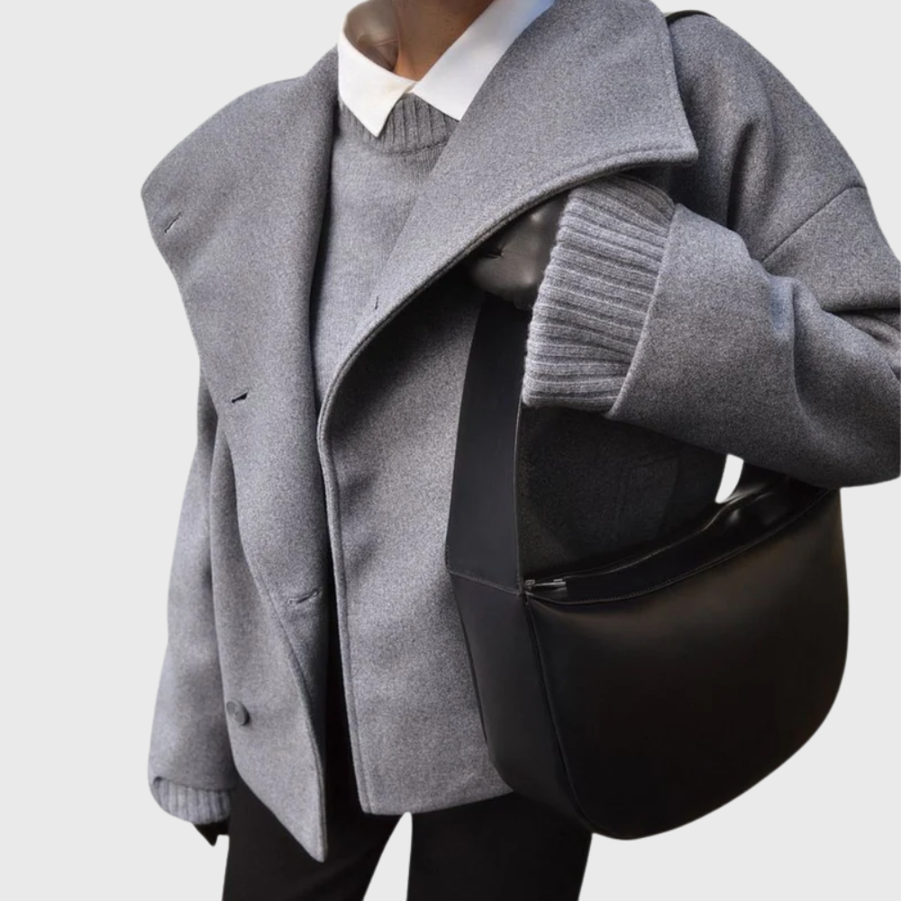 Statement women's cropped double-breasted coat with wide lapels. Fashion-forward outerwear jacket.