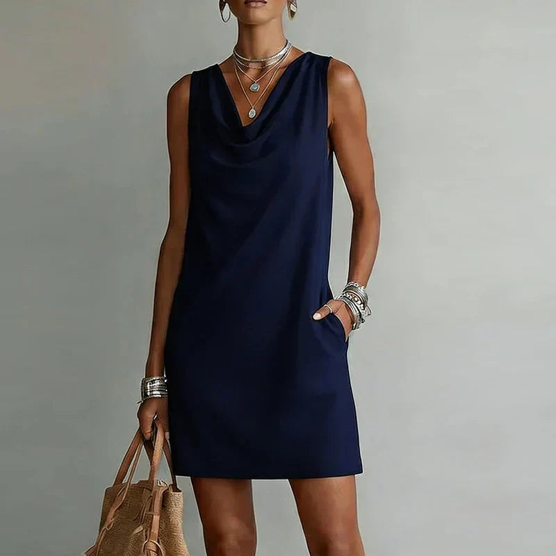 Sleeveless cowl neck mini dress for women, A-line cut, featuring convenient side pockets. Perfect for summer.