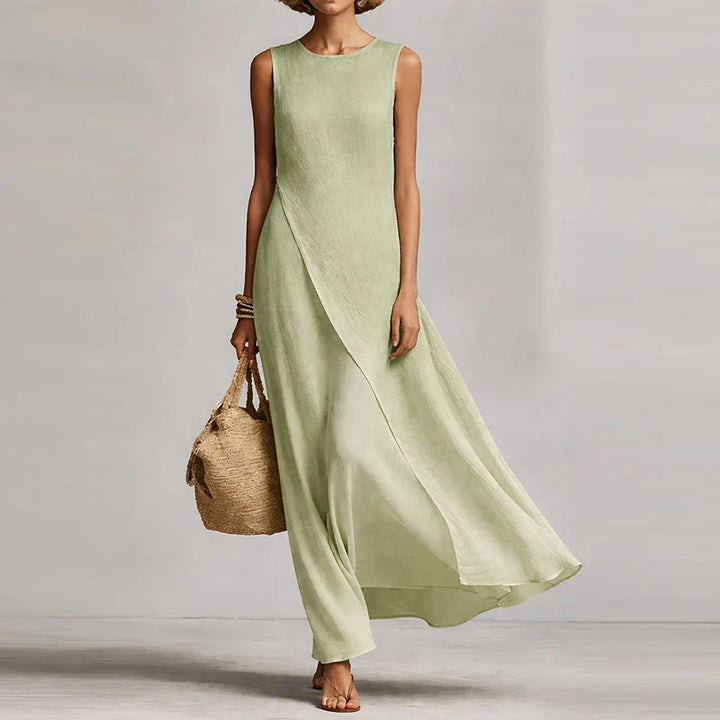 Comfortable flowy asymmetrical sleeveless maxi dress for women, offering an elegant summer beach look.