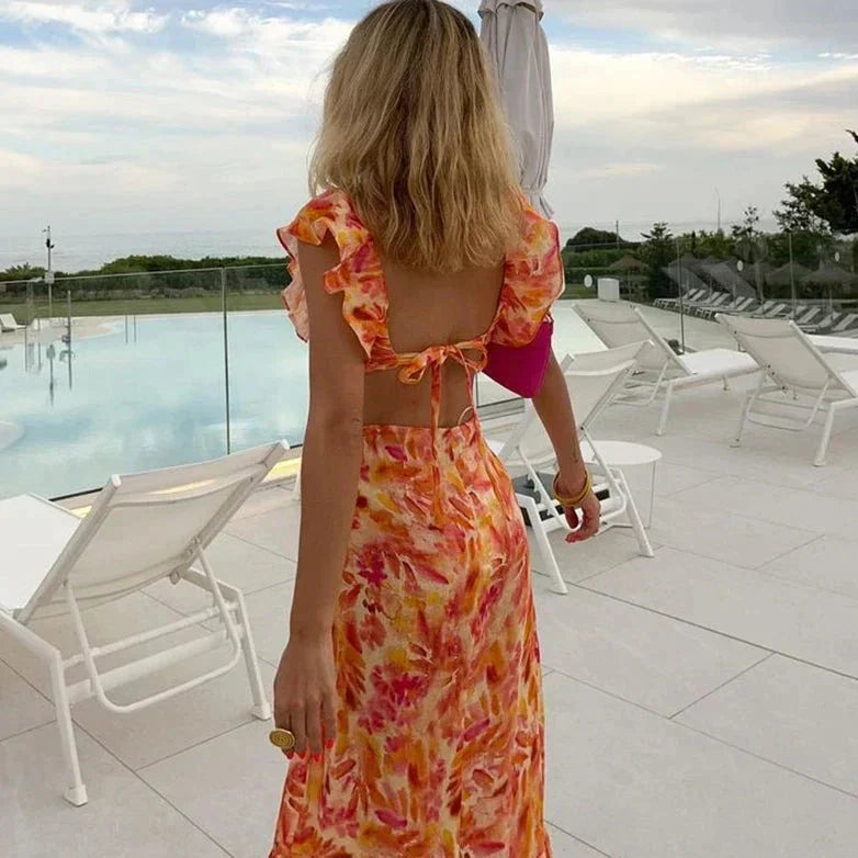 Flowy women's floral print maxi dress featuring ruffles & a V-neck, ideal for spring fashion & vacation wear.