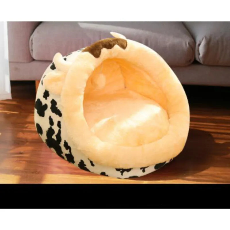 Cute cow print cat bed featuring adorable ears & horns. Soft plush pet bed, ideal for cozy kitten naps.