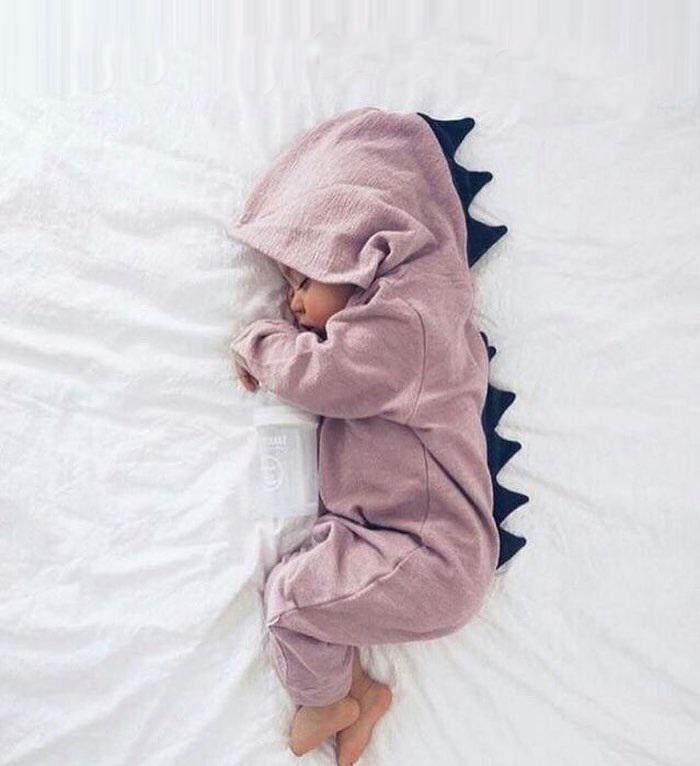 Adorable green baby dinosaur romper with 3D spikes for infants. Cozy and cute newborn outfit.