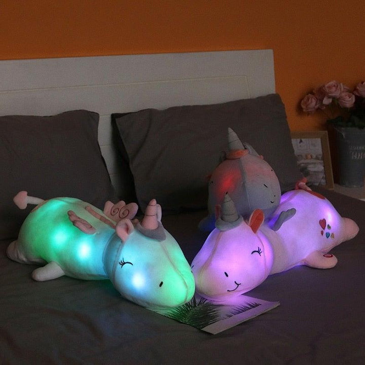 Soft plush unicorn toy with colorful lights, a comforting stuffed animal for children.