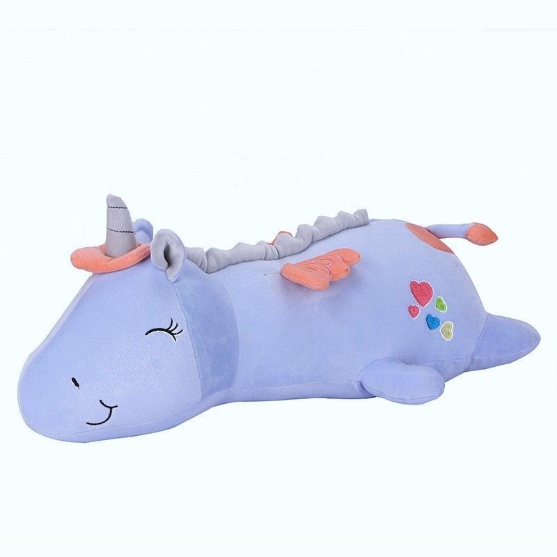 Close-up of a glowing plush unicorn's face, showing its soft texture and friendly expression.