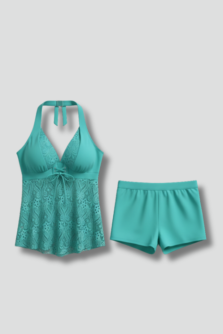 Women's deep teal blue V-neck tankini swimsuit with delicate lace overlay and matching swim shorts.