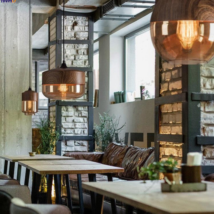 Close-up: Arven wooden pendant light showcasing natural wood grain & glass detail.