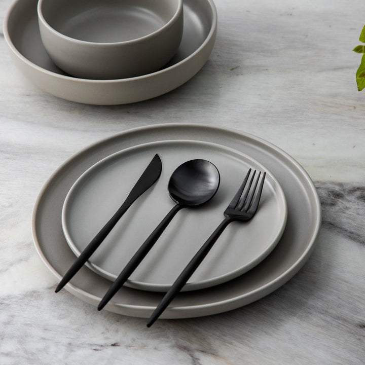 Full view of the Aurora Modern Cutlery Set laid out, reflecting light.