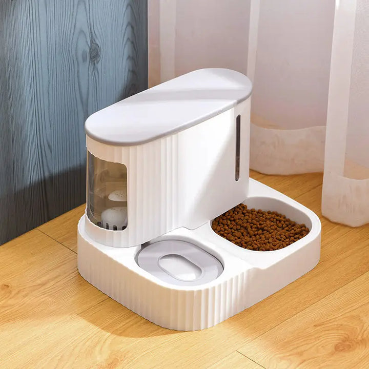 Pink automatic pet food & water dispenser for cats. Stylish pet feeder ensures continuous hydration & food supply.