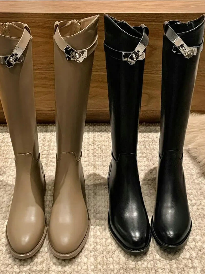 Elegant Aveline tall riding boots for women, showcasing sleek silhouette and exquisite metal hardware detail.