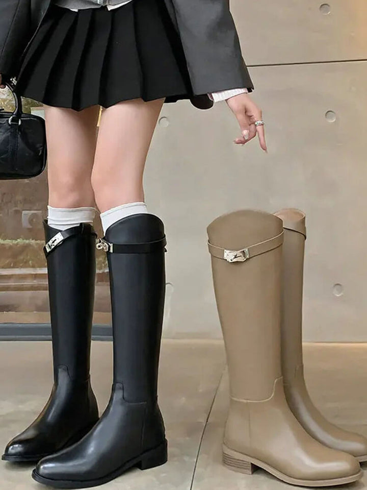 Classic Aveline women's tall riding boots in premium leather, timeless design enhanced by modern metal detail.