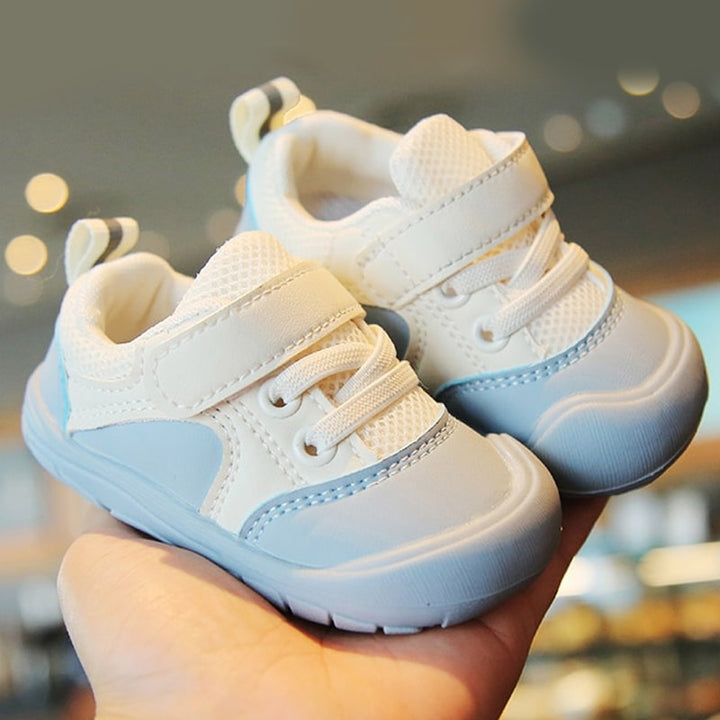 Side view of new Baby Barefoot Sneakers with flexible sole, ideal for infant first steps, breathable and lightweight.
