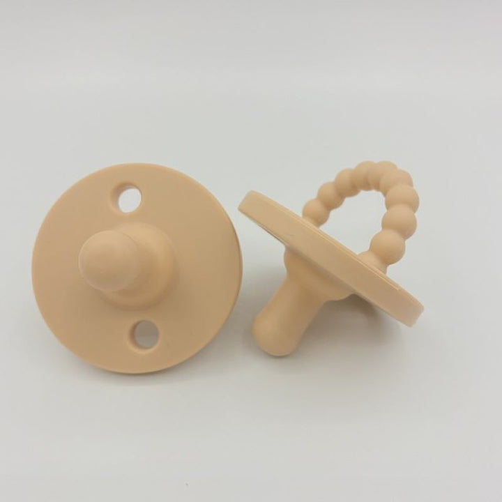 Ergonomic silicone baby pacifier & teether, designed for newborn comfort and effective gum soothing for infants.