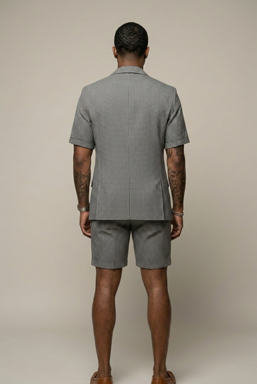 Matching men's black check blazer and shorts set, a tailored two-piece outfit for modern smart casual events.